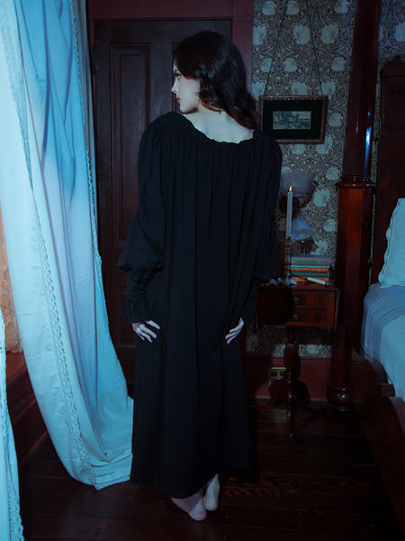 Romance and mystery blend in this black Victorian sleeping dress, crafted from silky fabric and highlighted by intricate ruffles and lace accents.