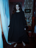 The epitome of vintage allure, this black Victorian sleeping dress showcases a timeless design with flowing fabric and delicate lace-trimmed sleeves.