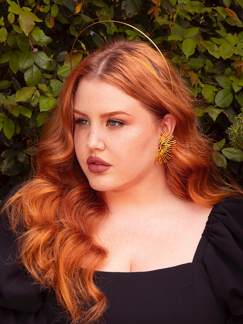 Radiate gothic allure with the Sunburst Fan Earrings in Gold. Each earring features a captivating sunburst design, evoking the enigmatic beauty of dawn and dusk. Perfect for moonlit soirées or secretive gatherings, these golden fans add a touch of celestial elegance to your look.