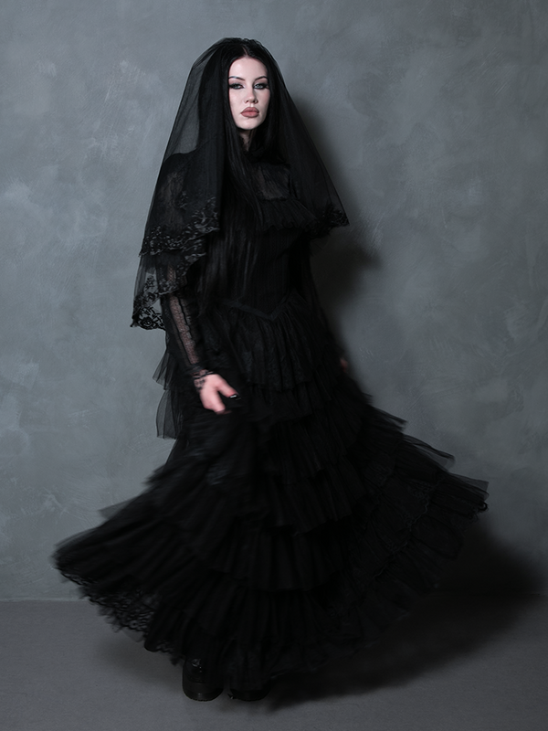 Woman modeling an exquisite midnight black formal dress perfect for an alternative gothic wedding.