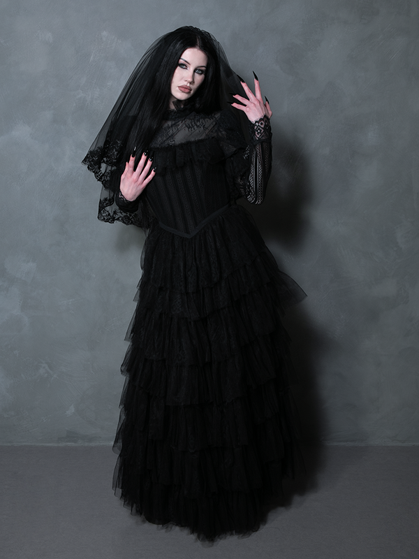 Female model wearing an elegant black gothic gown that captures the essence of dark macabre beauty.