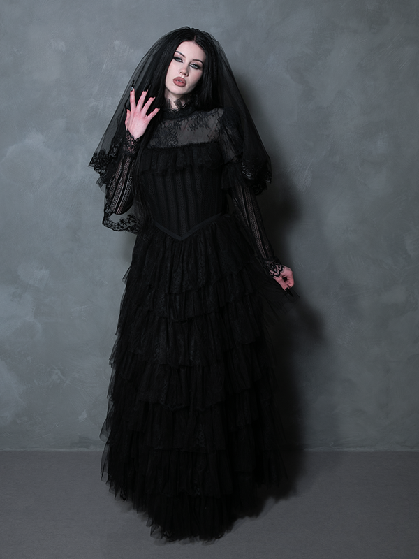 A female model embodying exquisite gothic romance in a dramatic black alternative wedding dress.