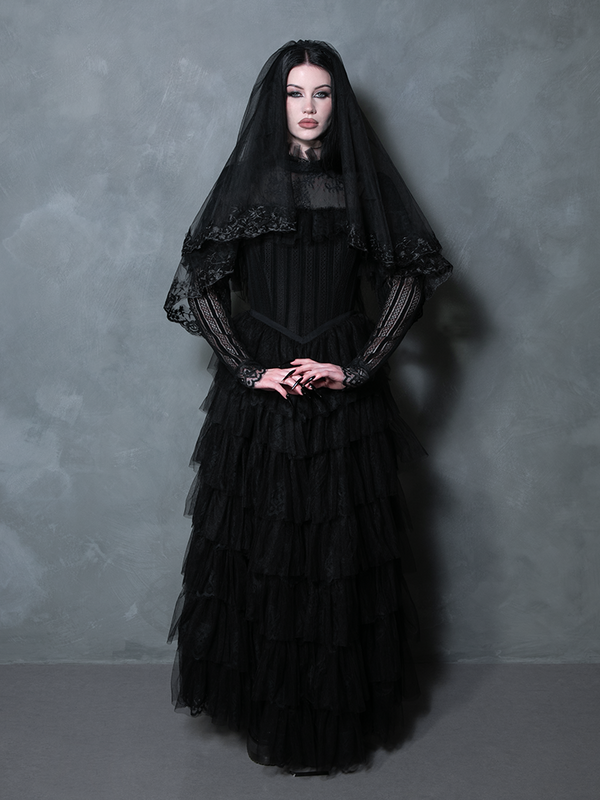 A stunning female model styled in a dramatic black gothic gown exuding Victorian elegance.