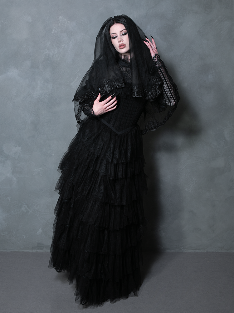 A captivating woman wearing a dark fantasy-inspired black dress that channels ethereal gothic beauty.