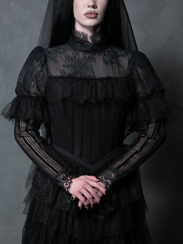 Female model presenting an ethereal black romantic gown designed for unforgettable dark aesthetics.