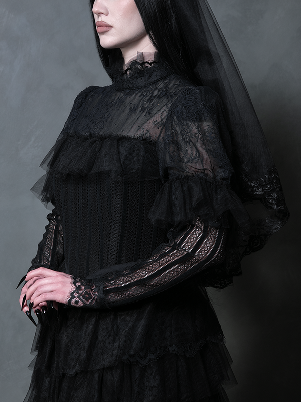 Woman wearing a majestic black alternative wedding gown steeped in enchanting dark fantasy fashion.