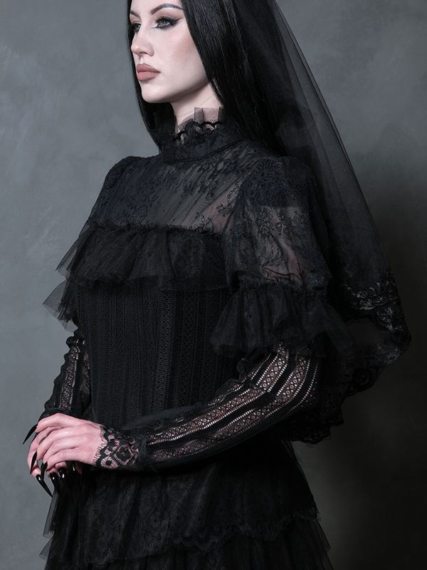 Female model wearing a breathtaking black alternative bridal dress embodying dark romantic formalwear.