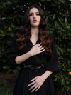 Sculpted noir hands create a striking focal point on this gothic glamour waist belt.