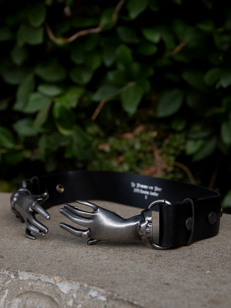 Clutching your form with Victorian finesse, these intricately detailed pewter hands turn a simple ensemble into a poetic silhouette of power.

