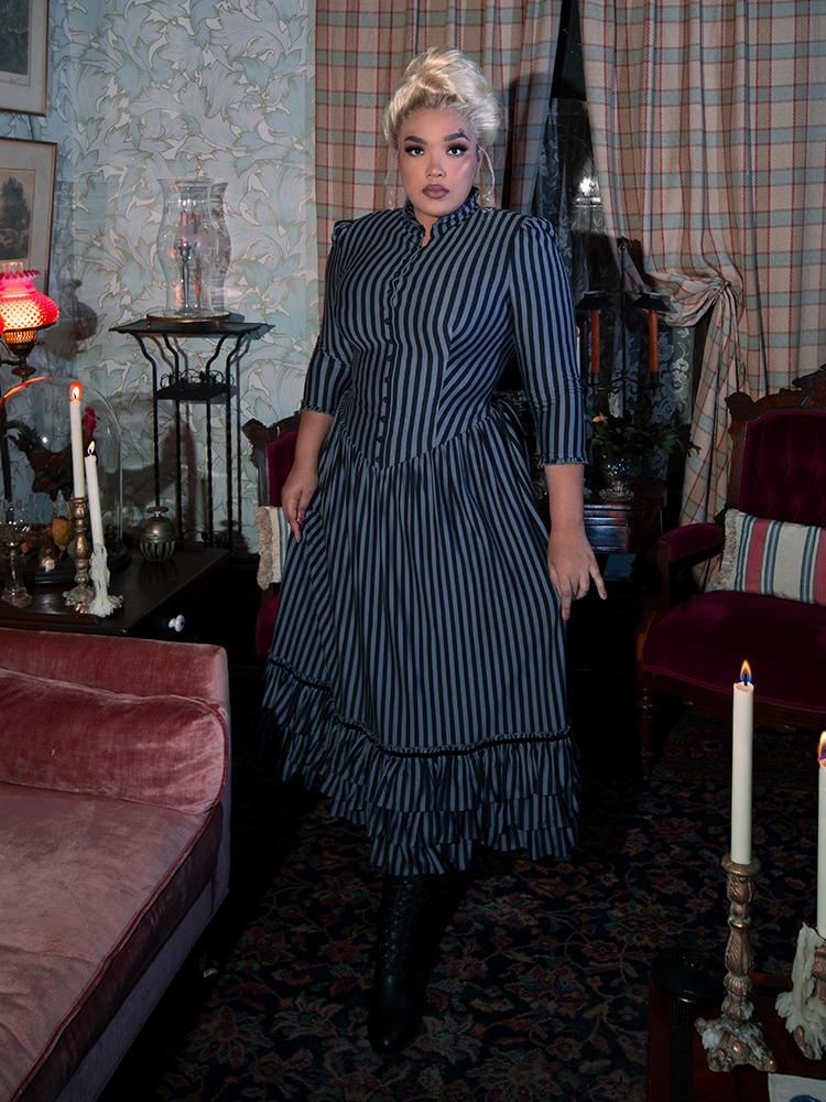 A beautifully tailored Victorian Dress in Black and Gray Stripes, featuring a structured silhouette, ruffled lace embellishments, and a striking color palette for a timelessly elegant look.