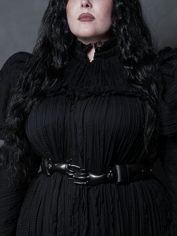 Channel Victorian Goth sophistication with this unique hand-clasp belt in a timeless black hue.