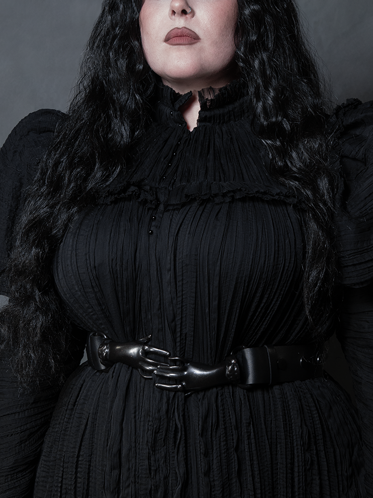 Channel Victorian Goth sophistication with this unique hand-clasp belt in a timeless black hue.