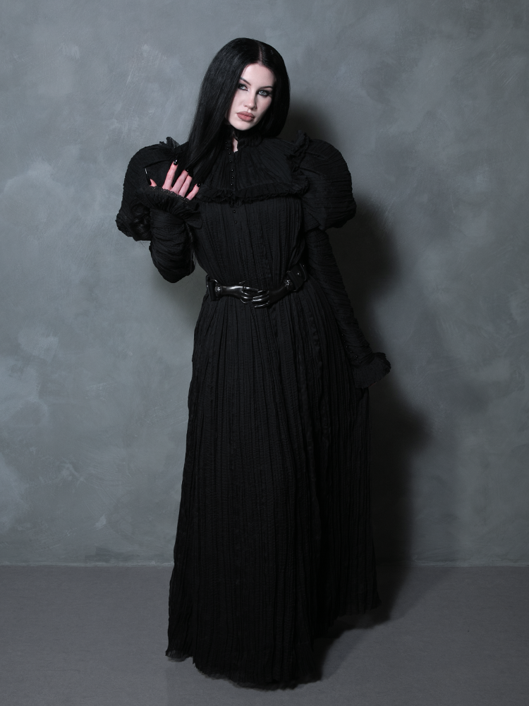Capturing a spirit of dark romance and dark elegance, a female model wears a luxurious black gothic clothing masterpiece.