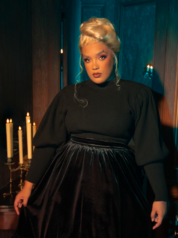 Gothic charm emanates as female models strike poses in the Victorian Cycling Pullover Sweater in Black, showcasing its unique design.