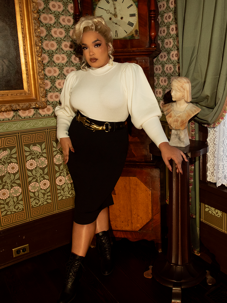 A piece of Victorian-inspired luxury, this ivory pullover brings warmth and poise with its puffed sleeves, structured bodice, and delicate old-world detailing.

