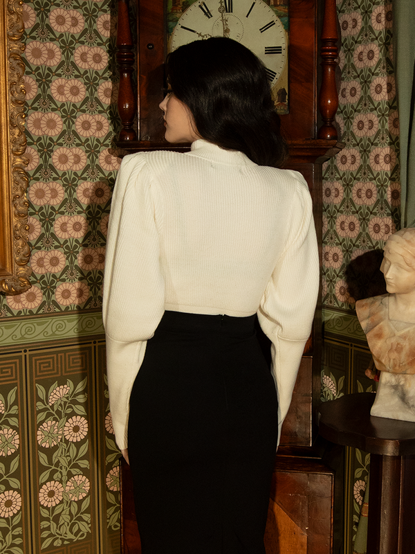 Step into history with this ivory Victorian pullover—its regal bishop sleeves and structured fit make it a striking yet wearable piece for any occasion.

