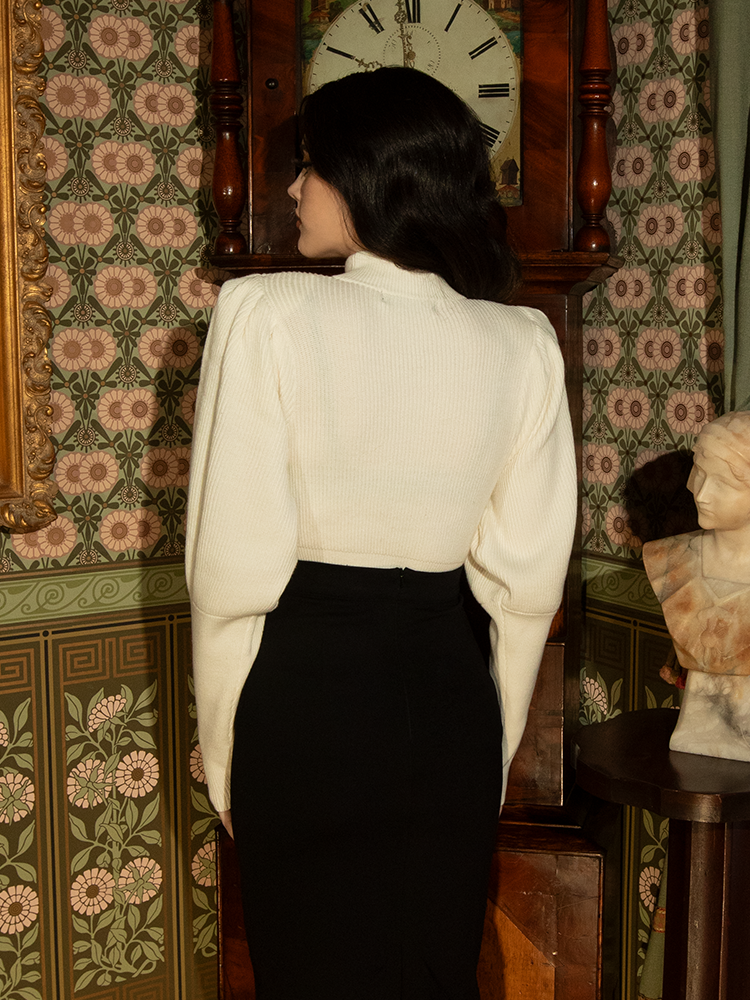 Step into history with this ivory Victorian pullover—its regal bishop sleeves and structured fit make it a striking yet wearable piece for any occasion.

