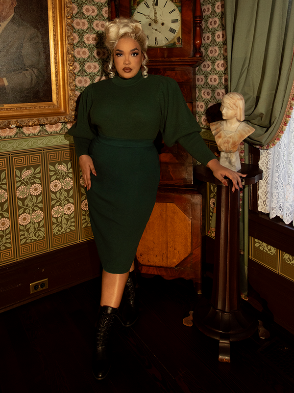 The Vamp Pencil Skirt in Hunter Green styled with a black lace corset, epitomizing the romantic goth and dark academia fashion trends.