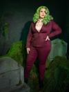 Dare to defy convention with the Beetlejuice™ Wedding Pants in sumptuous burgundy. These sleek, velvet pants embrace a striking gothic flair, ideal for those who weave mystery and elegance into their wardrobe, perfect for a moonlit vow or a midnight waltz.