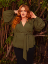 Embrace the allure of dusk with the Georgette Wrap Top in Olive. Its lightweight georgette fabric cascades gracefully, offering a perfect blend of comfort and gothic sophistication. Perfect for candlelit dinners or shadowy garden strolls, it transforms the ordinary into the extraordinary.