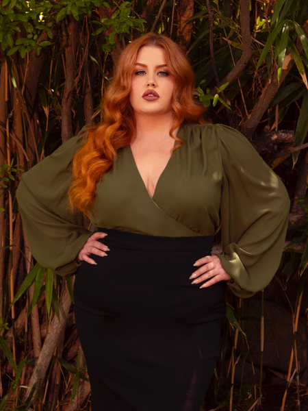 Discover the romance of the night with the Georgette Wrap Top in Olive. This enchanting top, crafted from delicate georgette, wraps around you like a whispering breeze. Whether paired with a flowing skirt or sleek trousers, it adds a touch of gothic elegance to any outfit.