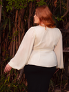 Step into the realm of celestial grace with the Georgette Wrap Top in Ivory. This enchanting piece, made from soft georgette, drapes like a whispering breeze, offering both comfort and gothic sophistication. Ideal for evening events or quiet mornings, it is a timeless addition to your wardrobe.