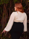 Discover the serenity of moonlight with the Georgette Wrap Top in Ivory. Crafted from delicate georgette, this top wraps you in a gentle embrace, perfect for intimate gatherings or serene daylight moments. Its graceful drape and soft hue exude gothic elegance.