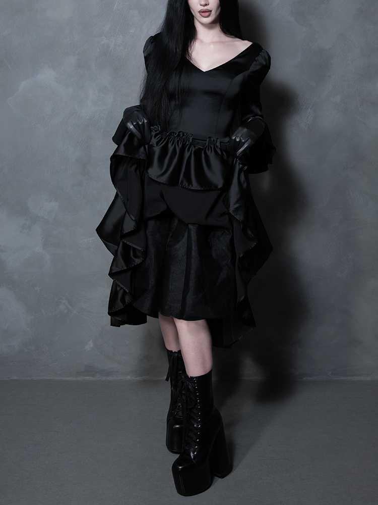 A breathtaking display of modern gothic clothing, a female model radiates dark romance in a midnight black satin gown.