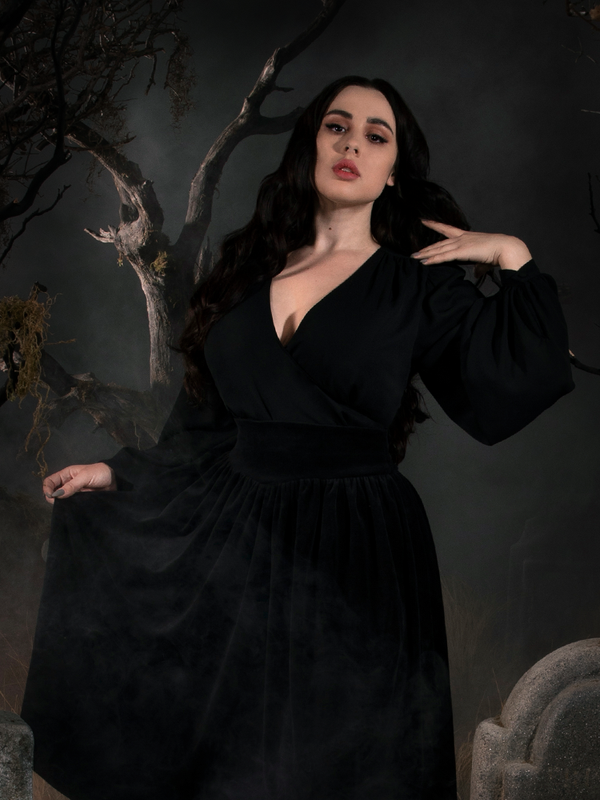 Rachel in a foggy cemetery scene, models the Georgette Wrap Top in Black from La Femme en Noir.