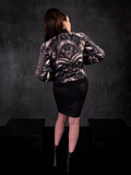 Micheline Pitt posing to show off the back of the Alien™ Xenomorph Bomber Jacket with iconic Xenomorph design.
