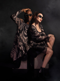 Micheline Pitt and Braxton Holmes wearing the Alien™ Xenomorph Trapeze Dress and Alien themed glasses from La Femme en Noir.