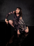 Micheline Pitt squats down into an attack pose while wearing the Alien™ Xenomorph Trapeze Dress.