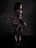 Back shot of the Alien™ Xenomorph Trapeze Dress worn by Micheline Pitt in a black and grey setting.