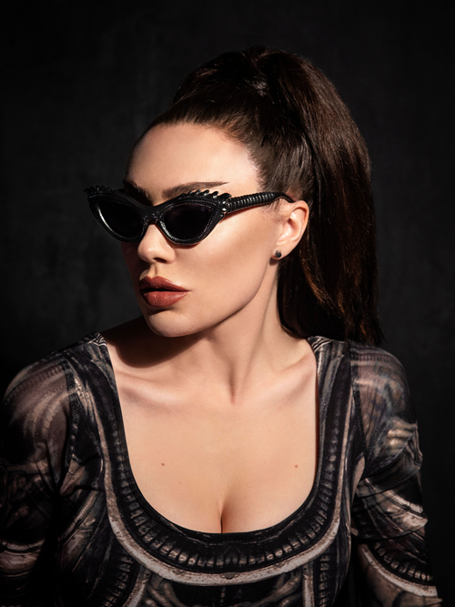 Micheline Pitt wearing the Alien™ Xenomorph Cat-Eye Sunglasses from gothic clothing brand La Femme en Noir.