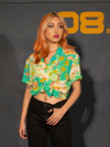 Female model with her thumb hanging from her front belt loop wearing the ALIEN Space Souvenir Button Up Shirt from La Femme en Noir.