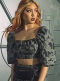 Female model wearing the ALIEN Xenomorph Hip Bag around her waist along with Alien inspired top.