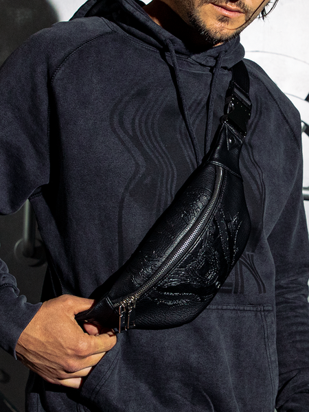 The ALIEN Xenomorph Hip Bag being worn by a male model over his shoulder and across his torso.