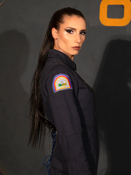 Shot from the waist up, KJ models the ALIEN Ripley Flight Suit in Navy and shows off the patch adoring the top of the sleeve.