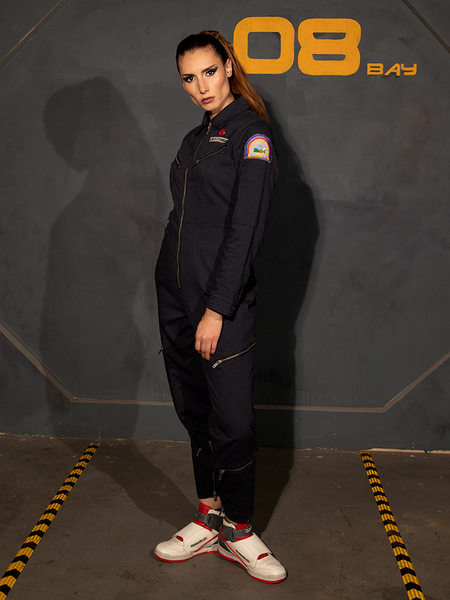 The ALIEN Ripley Flight Suit in Navy being worn by KJ; tall, brunette model with her hair pulled into a ponytail. 