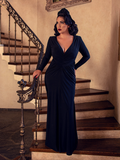 Erika stands in a palatial home while modeling the Art Deco ruched gown in black from La Femme En Noir.