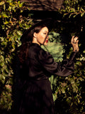 Micheline Pitt turned away from the camera showing off the gothic top Victorian Blouse in Black from La Femme en Noir.