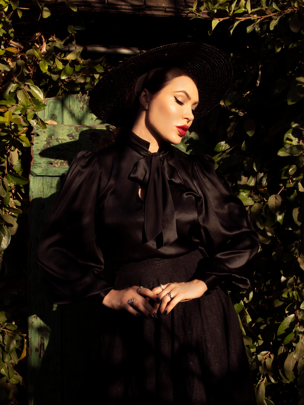 Micheline Pitt dressed all in black including the Victorian Blouse in Black from La Femme en Noir.