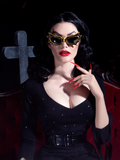 Heather Clarke channeling her inner Vampira while wearing the bat glasses in gold/black.
