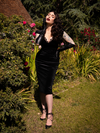 The Baudelaire Wiggle Dress in Black modeled by Micheline Pitt.