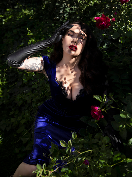 Partially shielded from the sun, Micheline Pitt shows off one of the newest goth style dresses from La Femme en Noir.