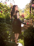 The back of the Baudelaire Swing Dress in Oxblood being worn by Micheline Pitt.