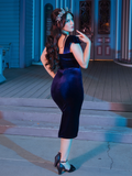 The Baudelaire Wiggle Dress in Midnight Blue shot from behind while being worn by model Ashley Thomson.
