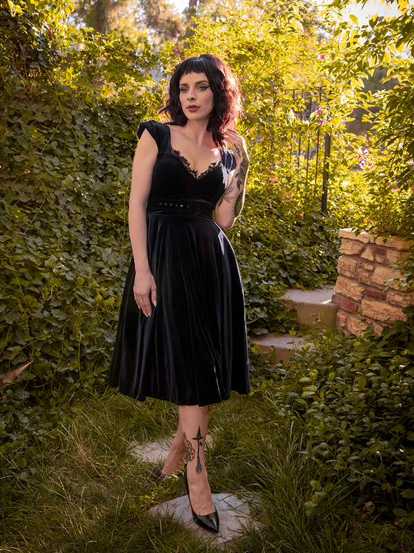 Stephanie gazing off camera while wearing the Baudelaire Swing Dress in Black from La Femme en Noir.
