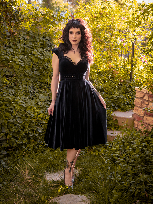 Full length shot of Stephanie posing in the Baudelaire Swing Dress in Black from gothic inspired dress company La Femme en Noir.