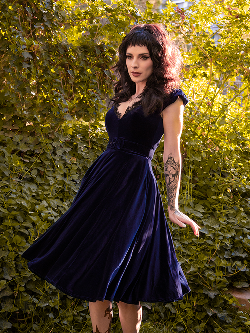 Stephanie is photographed mid-twirl in the Baudelaire Swing Dress in Midnight Blue.